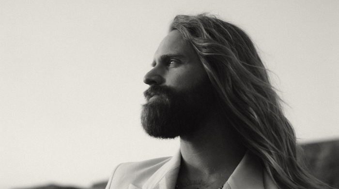 Musician Sam Ruder facing left in black and white.